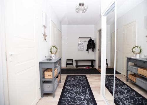 a hallway with a door and a rug at Arctic Circle Home in Rovaniemi