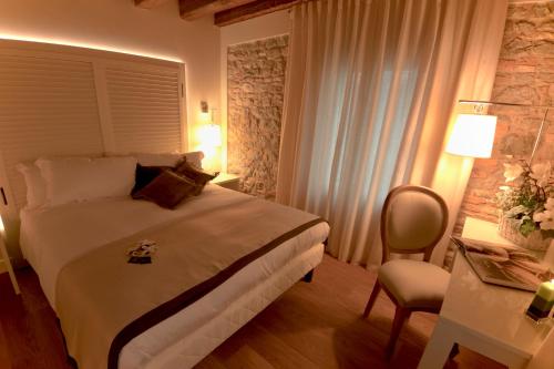 a bedroom with a large bed and a large window at Agriturismo Villa Trovatore in Cervignano del Friuli