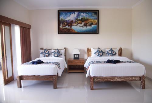 מיטה או מיטות בחדר ב-Davu Sundara Villa Uluwatu