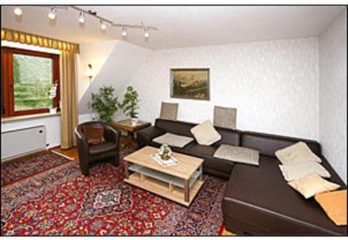 a living room with a couch and a table at Gästehaus Karbach in Oberwesel