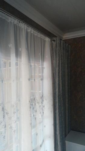 a curtain on a window in a room at Lalela House in Johannesburg