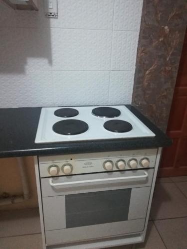 a stove top oven with a black counter top at Lalela House in Johannesburg