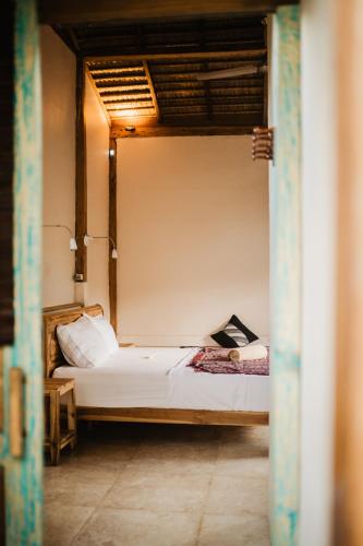 a bedroom with a bed in a room at Kalyssa Beach Bungalows in Pemuteran