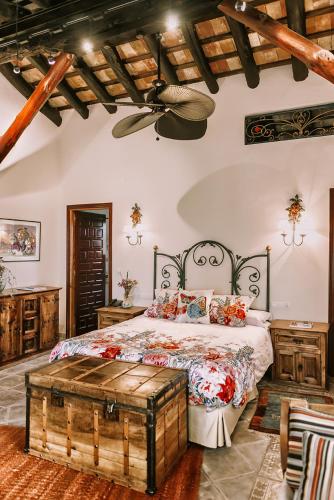 a bedroom with a large bed with a wooden headboard at Eco Hotel con encanto Masía la Mota B&B in Alcoy