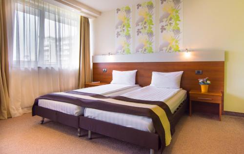 a bedroom with a large bed in a room at Hotel Forum - Free Parking for cars in Sofia