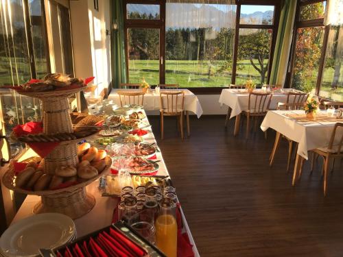 a long table with food on it in a restaurant at Landhotel Gasthof Eichhof Natters in Innsbruck