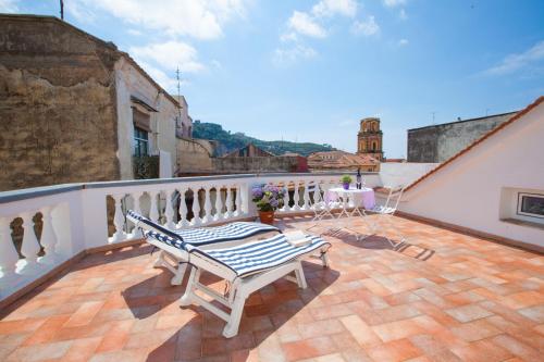 a balcony with a bench on top of a building at Sorrento Marida Rooms in Sorrento