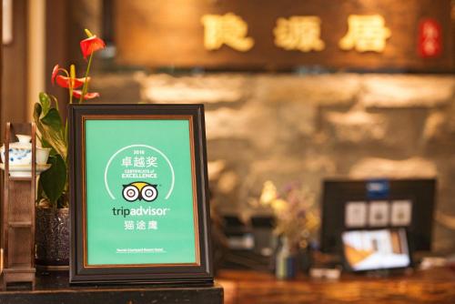 a framed sign sitting on a counter in a restaurant at Secret Courtyard Resort Hotel in Guilin
