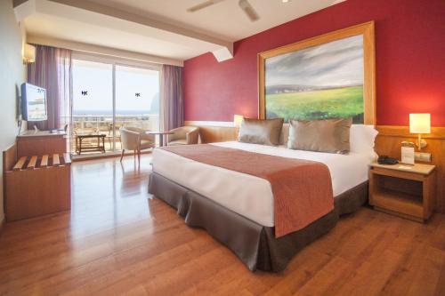 a bedroom with a large bed and a large window at Catalonia Majórica in Palma de Mallorca