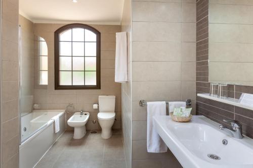 a bathroom with a tub and a toilet and a sink at Tagoro Family & Fun Costa Adeje in Adeje