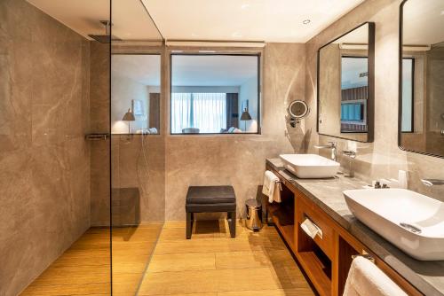 a bathroom with two sinks and a shower at Luxury Hotel Riva in Malinska