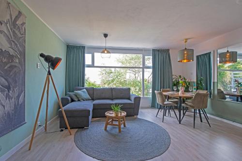 een woonkamer met een bank en een tafel bij Amsterdam Beach Apartment 65 in Zandvoort