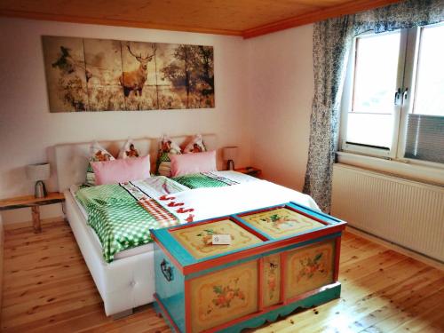 a bedroom with a bed with a dresser in it at Haus Moni in Bad Goisern