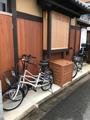 two bikes parked on the side of a building at 京町屋の宿悠路里 Kyo-Machiya YululY in Kyoto