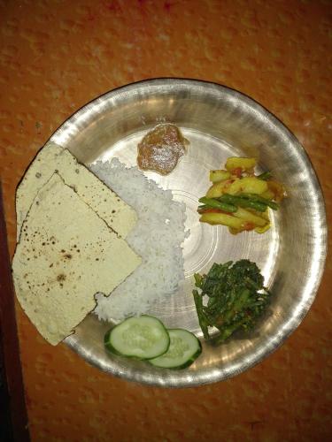 a plate of food with rice and vegetables on it at kayastha restaurant & lodge in Bandīpur