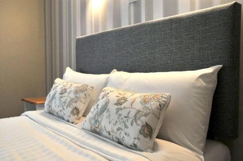 a bed with two pillows and a headboard at Killilagh Accommodation in Doolin