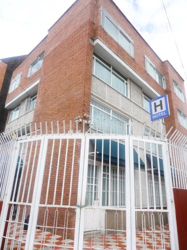 a brick building with a sign in front of it at Hotel Casa Sarita in Bogotá