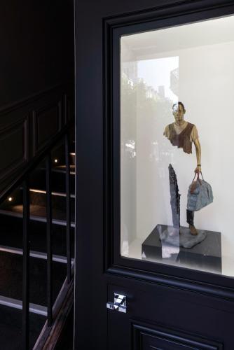 a statue of a man in a display window at Hôtel Le Presbytère in Paris