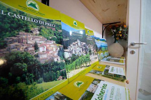 a bunch of posters hanging on a wall at Casale la Torretta in Norcia