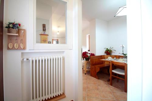 a dining room with a radiator and a dining table at Casale la Torretta in Norcia