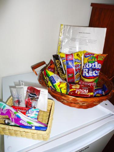 two baskets of chips on top of a refrigerator at Hotel Casa Sarita in Bogotá