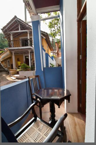 a table and a chair sitting on a porch at Hospedaria Abrigo De Botelho in Panaji