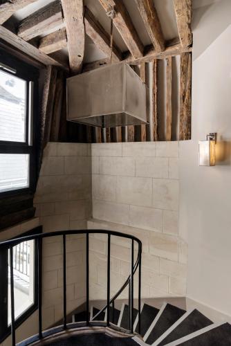 a kitchen with a stainless steel hood in a loft at Hôtel Le Presbytère in Paris