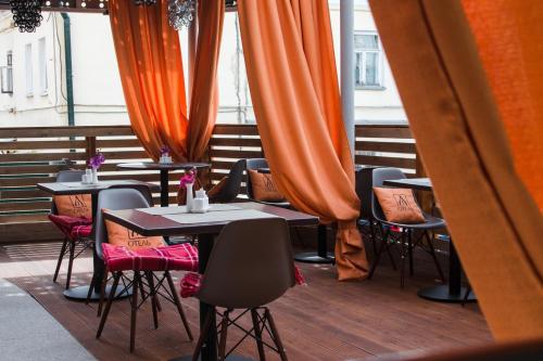コストロマにあるYa - Hotelのオレンジ色のカーテンが付いたバルコニー(テーブルと椅子付)