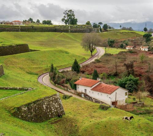 a farm with a building and a road in a field at Hostel Bulwark in Valença