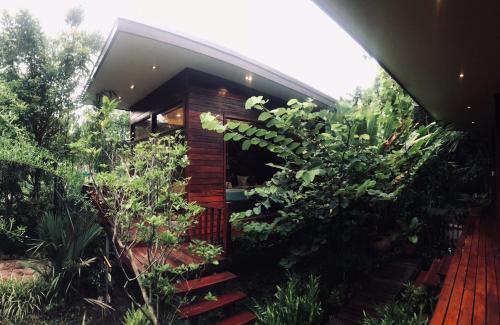 a house with a bunch of plants in front of it at 88 Homestay in Bang Chak
