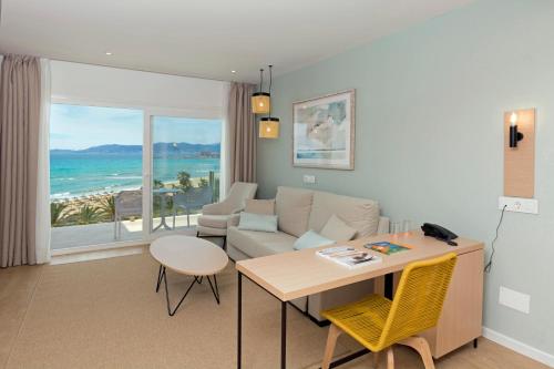 a living room with a couch and a table at HSM Golden Playa in Playa de Palma