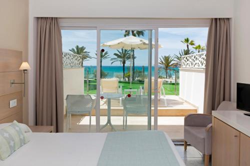 a bedroom with a bed and a view of the ocean at HSM Golden Playa in Playa de Palma