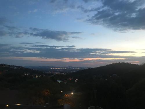 a view of a city from a hill at sunset at Bokamoso Views in Rustenburg