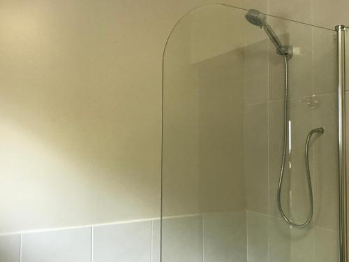 a shower with a glass door in a bathroom at Bokamoso Views in Rustenburg