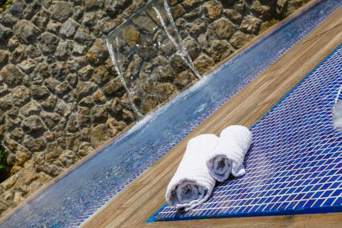 a pair of rolled towels on a swimming pool mat at Villa Palma Krk in Krk