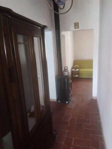 a hallway with a living room with a green couch at Magrignano in Montieri