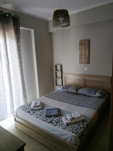 a bedroom with a bed with two towels on it at ΔΙΑΜΕΡΙΣΜΑ ΣΤΟ ΛΙΤΟΧΩΡΟ ΜΕ ΕΚΠΛΗΚΤΙΚΗ ΘΕΑ in Litochoro