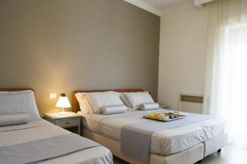 a bedroom with two beds with a tray of food on it at Resort Santangelo & SPA in Pimonte