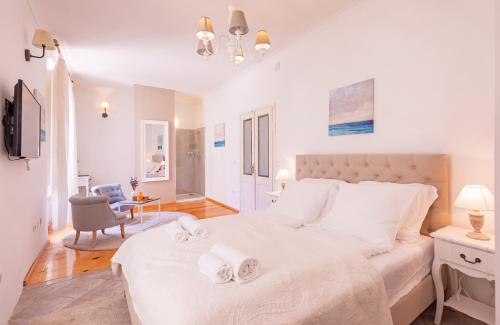 a bedroom with a large white bed with towels on it at Arty Old Town Apartments by Irundo in Dubrovnik