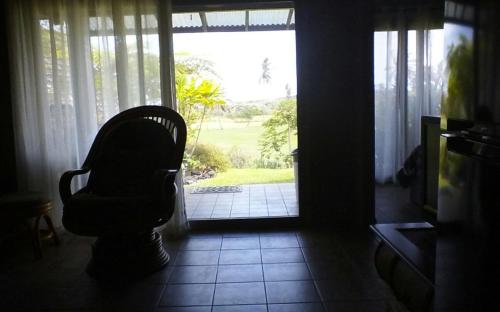 a chair sitting in front of a door at Mauna Kai'iki in Pahala