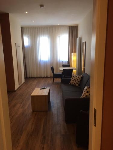 a living room with a couch and a table at 3 Apartments Am Wambolter Hof 3 in Bensheim