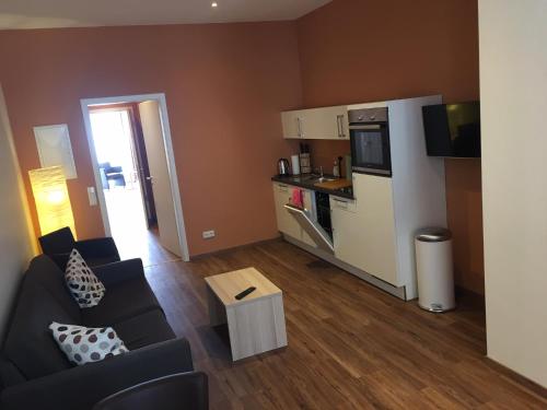 a living room with a couch and a kitchen at 3 Apartments Am Wambolter Hof 3 in Bensheim