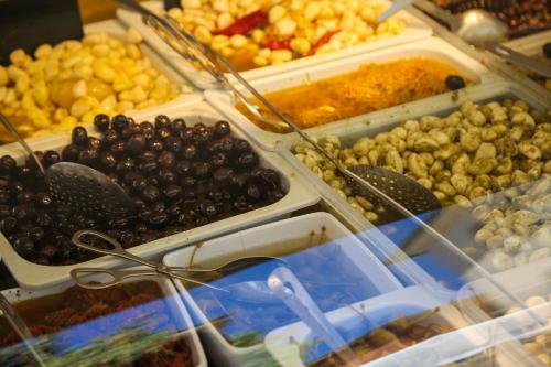 a buffet of different types of food in plastic containers at Hotel les Armoiries in Valbonne
