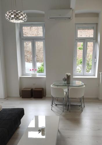 a living room with a table and a couch at Luxurios and historic apartment "Shine" - right on the Main Square in Zagreb