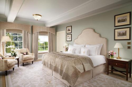 a bedroom with a large bed and a chair at Grantley Hall in Ripon