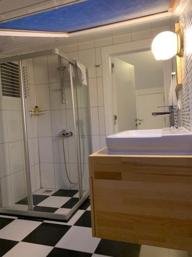 a bathroom with a shower and a sink and a mirror at The Townhouse Apartment in Kas
