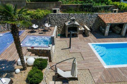 a backyard with a swimming pool and a swimming pool at Apartments Petra Krk in Krk