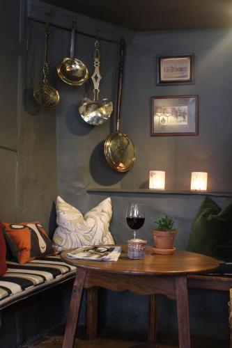 a living room with a table and a couch at The Lamb Inn in Burford