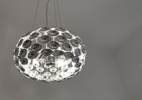 a silver light fixture hanging from a ceiling at Luxurios and historic apartment "Shine" - right on the Main Square in Zagreb