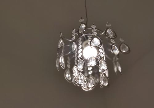 a silver chandelier hanging from a ceiling at Luxurios and historic apartment "Shine" - right on the Main Square in Zagreb